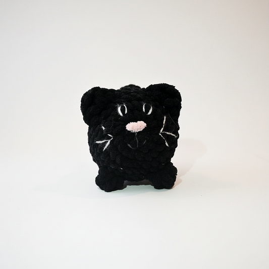Black plush toy on a white background
