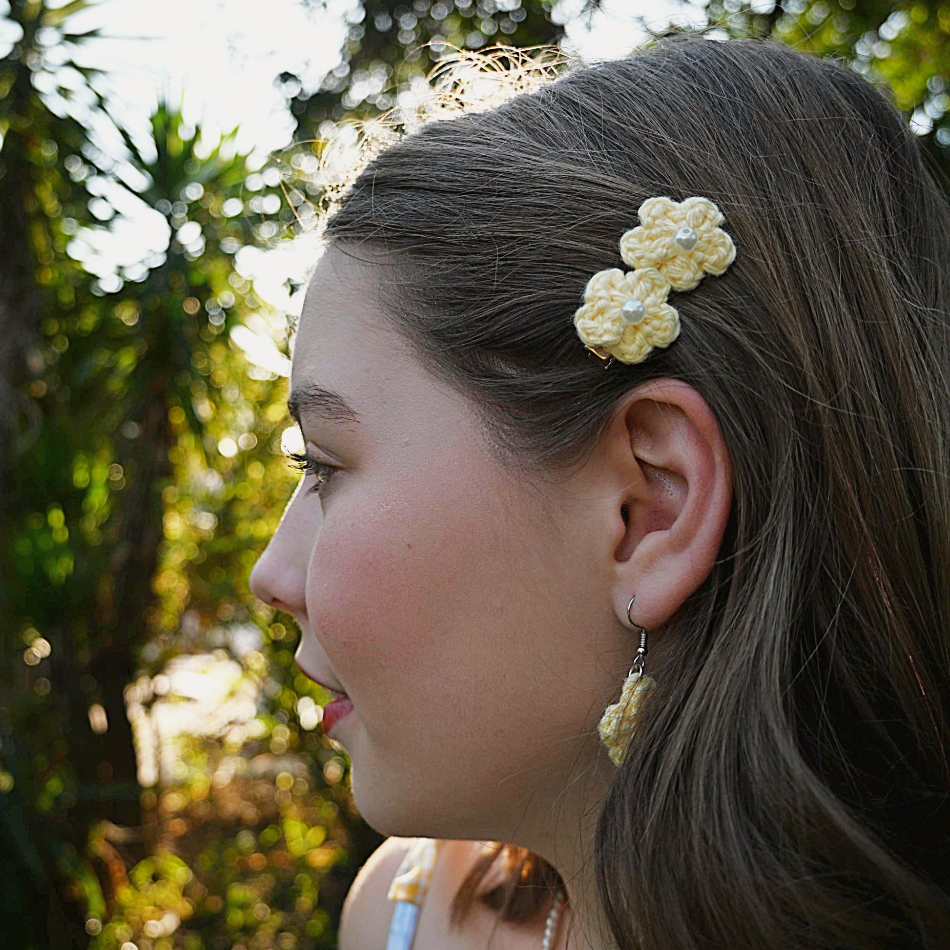 Woman with a floral hair clip in a natural setting