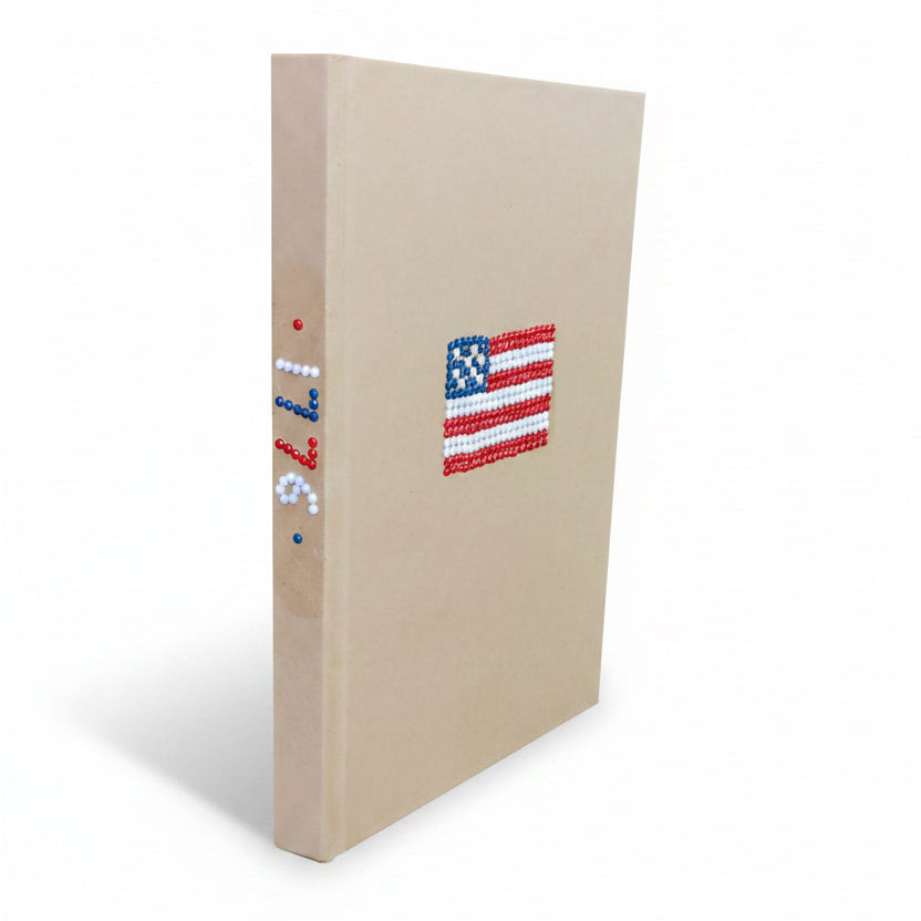 Beige notebook with a small American flag on a white background